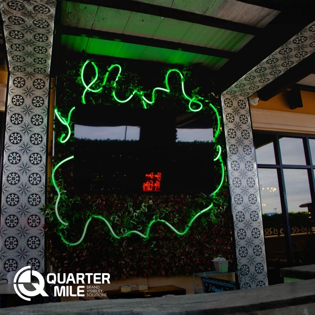 Custom acrylic LED panels with branded pattern at Colmena outdoor patio bar