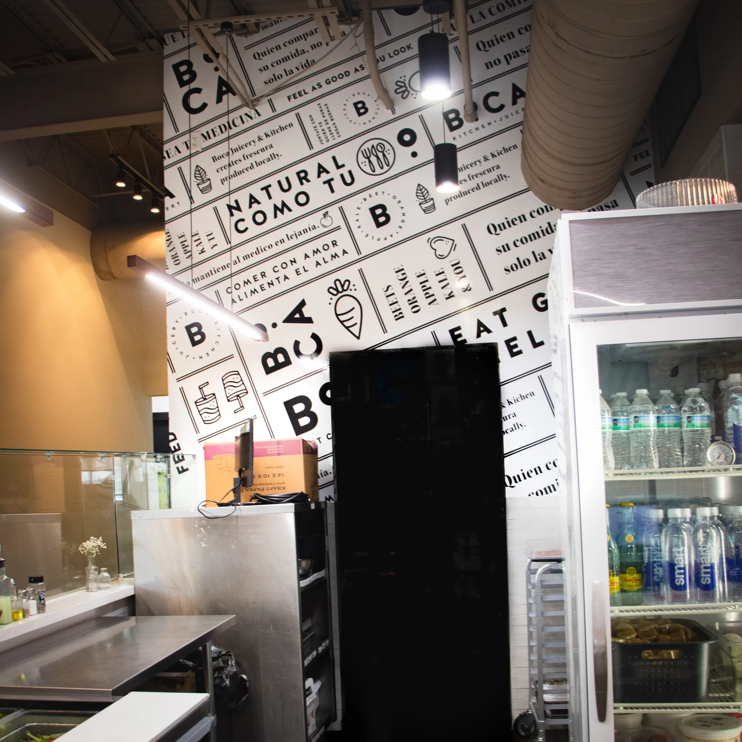 Custom black and white typographic wall wrap inside Bolillos Café